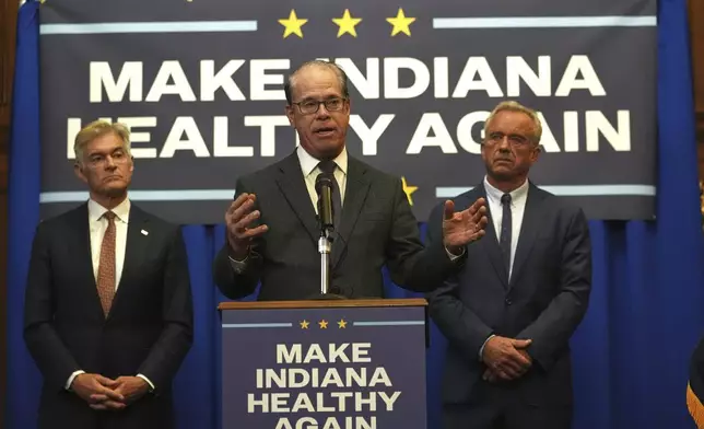 FILE - Indiana Governor Mike Braun is joined by U.S. Health and Human Services Secretary Robert F. Kennedy, Jr, right, and Centers for Medicare and Medicaid Services Administrator Dr. Mehmet Oz during a news conference in Indianapolis, April 15, 2025. (AP Photo/Michael Conroy, File)