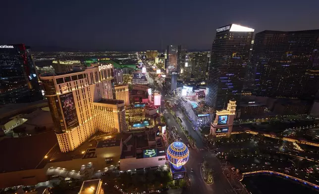Cars drive along the Las Vegas Strip, Saturday, Aug. 2, 2025, in Las Vegas. (AP Photo/John Locher)