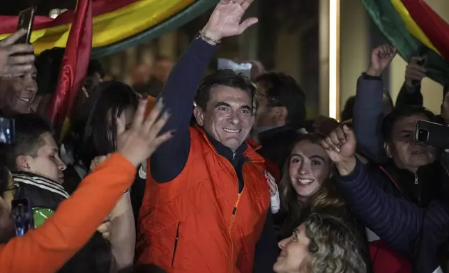 FILE - Presidential candidate Sen. Rodrigo Paz, center, waves to supporters after early results showed him leading in the presidential election in La Paz, Bolivia, Aug. 17, 2025. (AP Photo/Natacha Pisarenko, File)