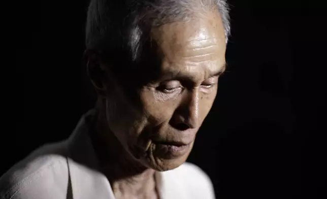 FILE - Sumiteru Taniguchi, 86, a survivor of the 1945 atomic bombing of Nagasaki, pauses during an interview at his office in Nagasaki, southern Japan, June 30, 2015. (AP Photo/Eugene Hoshiko, File)