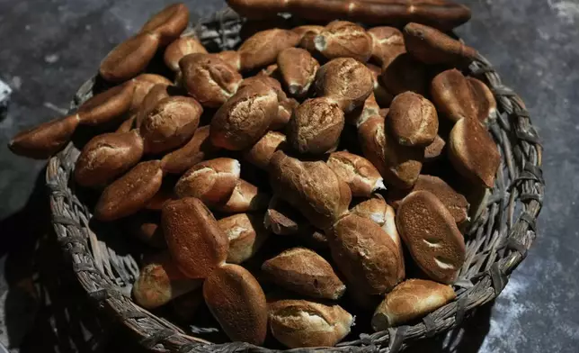 Freshly baked bread called "pan de batalla," or battle bread, which uses government subsidized flour, sits in a basket at a bakery in El Alto, Bolivia, Friday, Aug. 8, 2025. (AP Photo/Juan Karita)