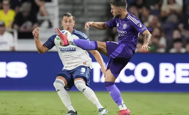Orlando City forward Marco Pašalić, right, kicks the ball past Nashville SC defender Tate Schmitt (3) during the second half of an MLS soccer match Saturday, Aug. 23, 2025, in Nashville, Tenn. (AP Photo/George Walker IV)