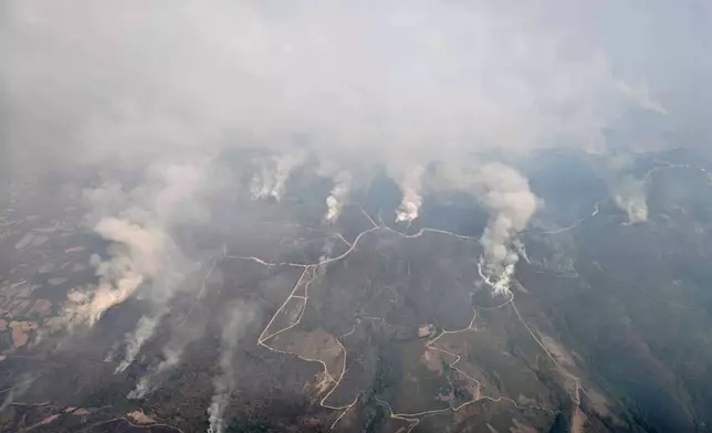 This recent photo taken from a French Canadair water bomber and provided Friday, Aug. 15, 2025 by the Securite Civile shows wildfire in Spain. (Securite Civile via AP)