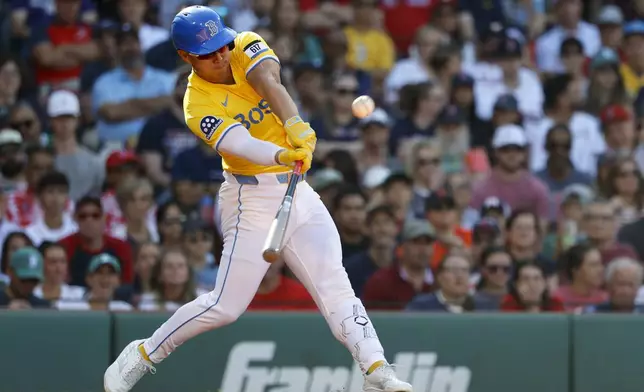 Boston Red Sox's Rob Refsnyder hits an RBI single in the third inning of a baseball game against the Houston Astros, Saturday, Aug. 2, 2025, in Boston. (AP Photo/Greg M. Cooper)