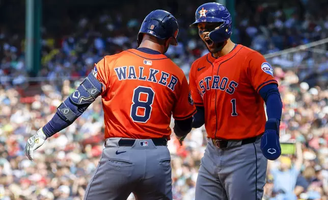 Houston Astros' Christian Walker (8) celebrates with Carlos Correa (1) after hitting a two run homer in the first inning of a baseball game, Saturday, Aug. 2, 2025, in Boston. (AP Photo/Greg M. Cooper)