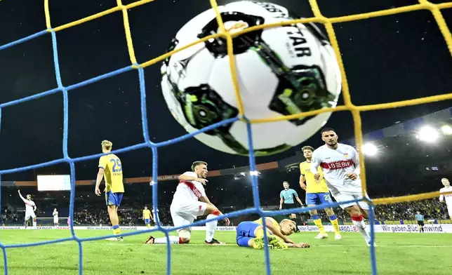 VfB Stuttgart's Ermedin Demirovi, center left, reacts after scoring a goal against Eintracht Braunschweig during a DFB Pokal, German Cup, soccer match, Tuesday, Aug. 26, 2205, in Brunswick, Germany. (Swen Pförtner/dpa via AP)