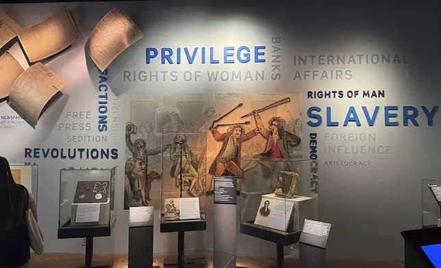 This wall in the “Great Debate” section of a democracy exhibit at the National Museum of American History, shown Aug. 26, 2025, in Washington, reflects some of the issues the nation grapples with. President Donald Trump is pressing for changes in the stories the Smithsonian museums tell about America. He wants U.S. history cast in a more positive light. (AP Photo/Calvin Woodward)