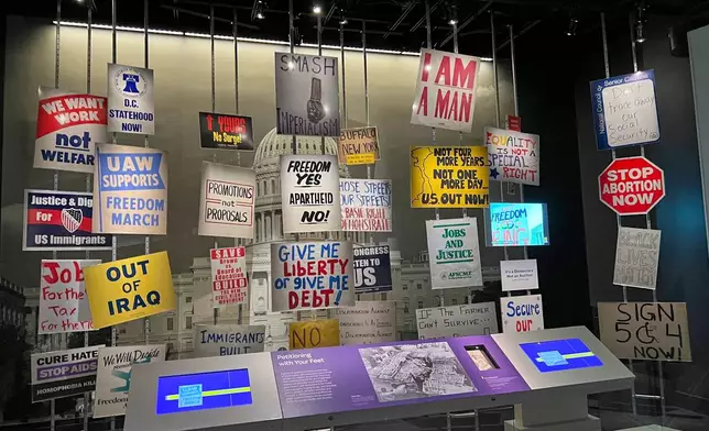 Protest signs from a selection of historic demonstrations are displayed at the Smithsonian’s National Museum of American History, Aug. 13, 2025, representing the causes of anti-war and civil rights activists, the tea party, farmers and other populist movements. (AP Photo/River Zhang)
