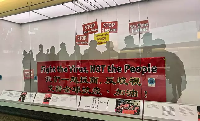 A “Fight the Virus, Not the People” COVID-19 banner at the Smithsonian’s National Museum of American History on Aug. 13, 2025. The banner was carried by counter-protesters at an anti-Asian hate march in San Francisco in February 2020. It is the museum’s most recent collection related to the pandemic. (AP Photo/River Zhang)