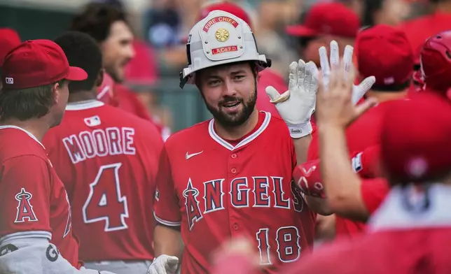 Los Angeles Angels' Nolan Schanuel celebrates in the dugout after hitting a two-run home run during the fourth inning of a baseball game against the Detroit Tigers, Sunday, Aug. 10, 2025, in Detroit. (AP Photo/Ryan Sun)