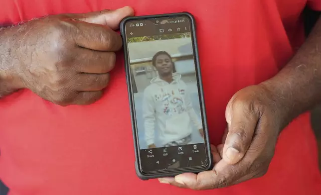 John Terry holds a photograph of his son Jalen Wilkinson, Saturday, April 26, 2025, in Haines City, Fla. Jalen's academic experience changed when the detention center he was in switched to virtual learning. (AP Photo/Marta Lavandier)