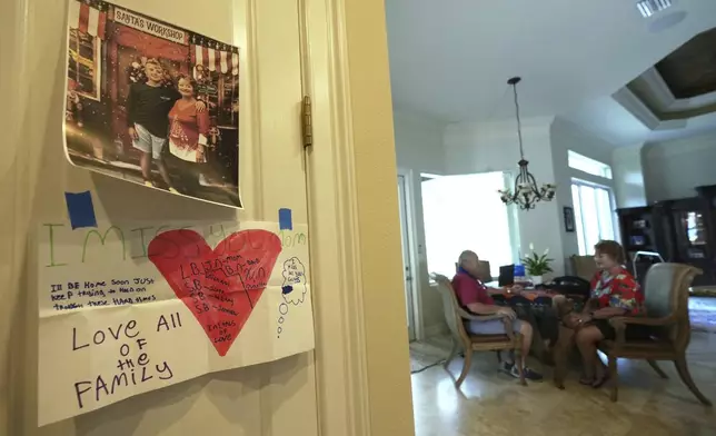 A photo and letter from Xavier Nicoll is posted on the kitchen of his grandparents Bill and Julie's home Thursday, April 24, 2025, in Naples, Fla. Xavier has been incarcerated longer than his original sentence due behavioral issues during virtual school. (AP Photo/Marta Lavandier)