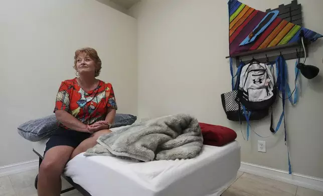 Julie Nicoll sits in her grandson Xavier's bedroom Thursday, April 24, 2025, in Naples, Fla., after Xavier's juvenile detention sentence was lengthened for breaking multiple laptops out of frustration with online learning. . (AP Photo/Marta Lavandier)