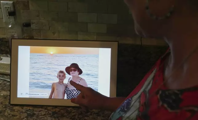 Julie Nicoll shows shows an undated photo with her grandson Xavier Thursday, April 24, 2025, in Naples, Fla. Julie and her husband have spent more than $20,000 in legal fees trying to get him released from a youth detention center. (AP Photo/Marta Lavandier)