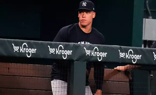 New York Yankees Aaron Judge looks on from the dugout during the second inning of a baseball game against the Texas Rangers, Monday, Aug. 4, 2025, in Arlington, Texas. (AP Photo/LM Otero)
