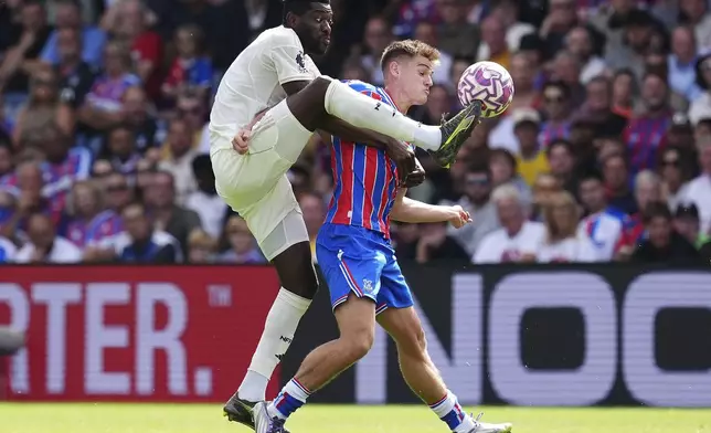 Crystal Palace's Justin Devenny, right, and Nottingham Forest's Ibrahim Sangare battle for the ball during the English Premier League soccer match between Crystal Palace and Nottingham Forest at Selhurst Park, London, Sunday, Aug. 24, 2025. (John Walton/PA via AP)