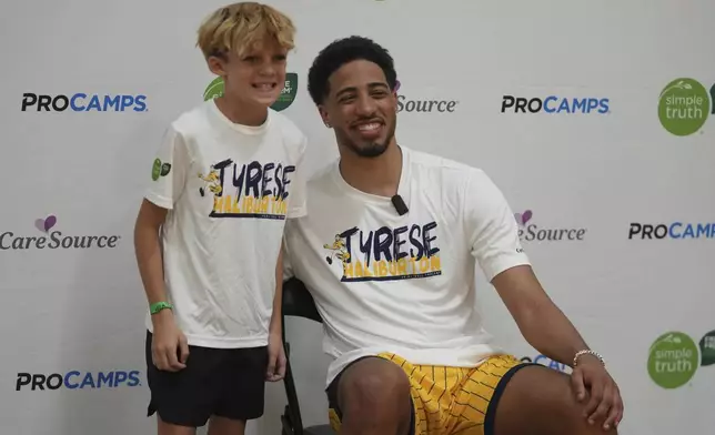 Indiana Pacers' Tyrese Haliburton poses for a photo with Broden Barkhimer during his basketball camp, Saturday, Aug. 23, 2025, in Westfield, Ind. (AP Photo/Darron Cummings)