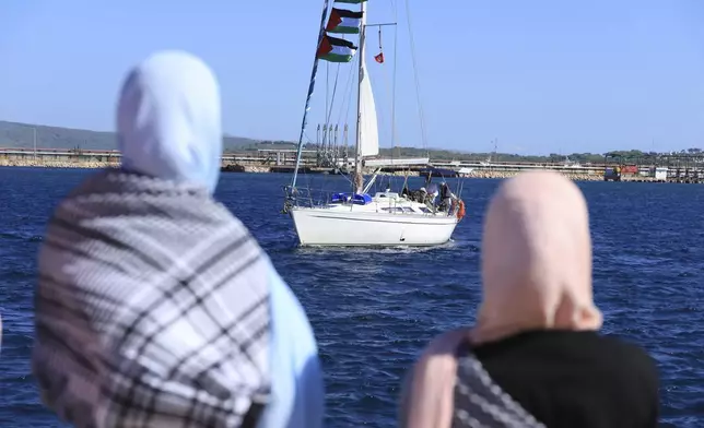 Supporters watch as a boat that is part of the Global Sumud Flotilla departs to Gaza to deliver aid amidst Israel's blockade on the Palestinian territory, in the Tunisian port of Bizerte, Saturday, Sept. 13, 2025. (AP Photo/Anis Mili)