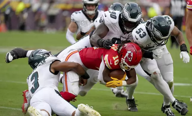 Kansas City Chiefs running back Isiah Pacheco (10) is tackled by Philadelphia Eagles' Nolan Smith (3), Jordan Davis (90) and Zack Baun (53) during the second half of an NFL football game Sunday, Sept. 14, 2025, in Kansas City, Mo. (AP Photo/Ed Zurga)