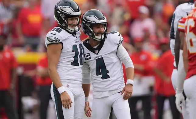Philadelphia Eagles place kicker Jake Elliott (4) is congratulated by teammate Braden Mann (10) after making a 51-yard field goal during the second half of an NFL football game against the Kansas City Chiefs Sunday, Sept. 14, 2025, in Kansas City, Mo. (AP Photo/Charlie Riedel)