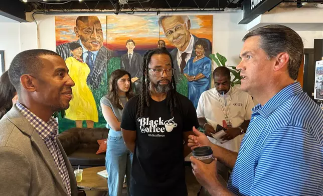 Former Republican lieutenant governor Geoff Duncan, right, speaks about his Democratic campaign for governor Wednesday, Sept. 17, 2025, at Black Coffee Co., in Atlanta. (AP Photo/Jeff Amy)