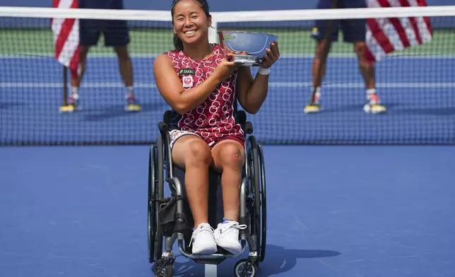 Yui Kamiji, of Japan, holds up the championship trophy after defeating Li Xiaohui, of China, in the wheelchair women's singles final of the U.S. Open tennis championships, Saturday, Sept. 6, 2025, in New York. (AP Photo/Kirsty Wigglesworth)