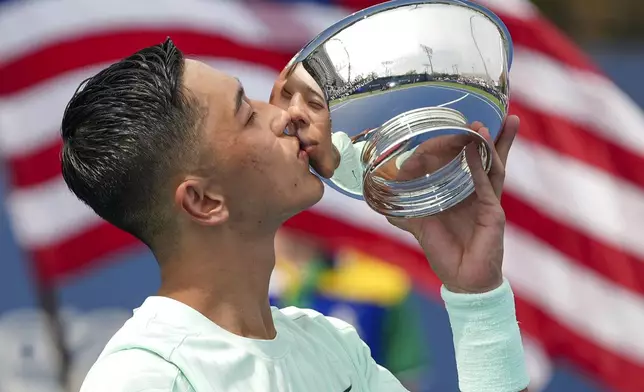 Tokito Oda, of Japan, kisses the championship trophy after defeating Gustavo Fernandez, of Argentina, in the wheelchair men's singles final of the U.S. Open tennis championships, Saturday, Sept. 6, 2025, in New York. (AP Photo/Frank Franklin II)