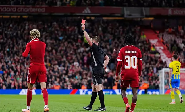 Liverpool's Hugo Ekitike gets a red card after taking his shirt off after scores his side's second goal during the English League Cup third round soccer match between Liverpool and Southampton at the Anfield stadium in Liverpool, England, Tuesday, Sept. 23, 2025. (Peter Byrne/PA via AP)