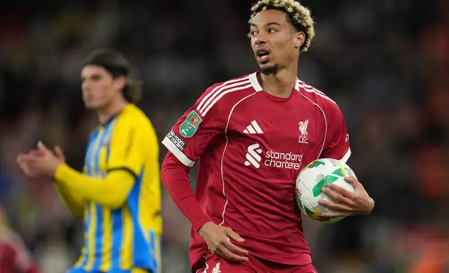 Liverpool's Hugo Ekitike holds the ball during the English League Cup third round soccer match between Liverpool and Southampton at the Anfield stadium in Liverpool, England, Tuesday, Sept. 23, 2025. (AP Photo/Jon Super)