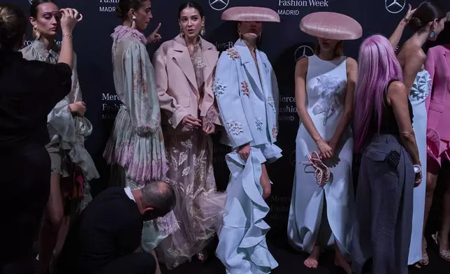 Models wear designs by Isabel Sanchis backstage during the brand's show at Fashion Week in Madrid, Spain, Friday, Sept. 19, 2025. (AP Photo/Manu Fernandez)