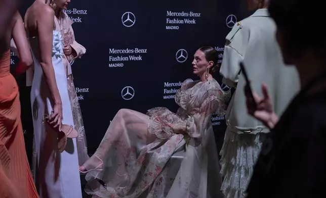 Models wear designs by Isabel Sanchis backstage during the brand's show at Fashion Week in Madrid, Spain, Friday, Sept. 19, 2025. (AP Photo/Manu Fernandez)