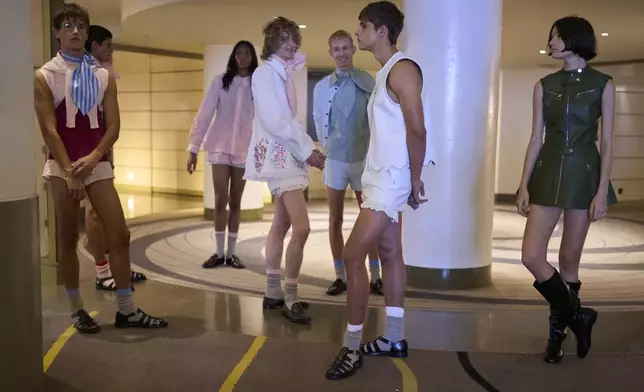 Models wear designs by Palomo backstage before the brand's show at Fashion Week in Madrid, Spain, Wednesday, Sept. 17, 2025. (AP Photo/Manu Fernandez)