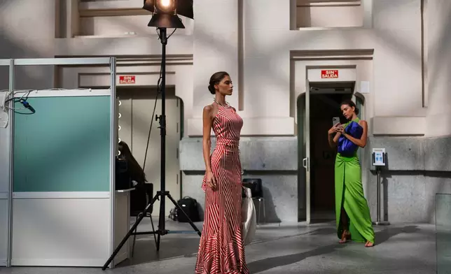 A model poses backstage before presenting designs by Silvia Tcherassi at the brand's show during Fashion Week in Madrid, Spain, Wednesday, Sept. 17, 2025. (AP Photo/Manu Fernandez)