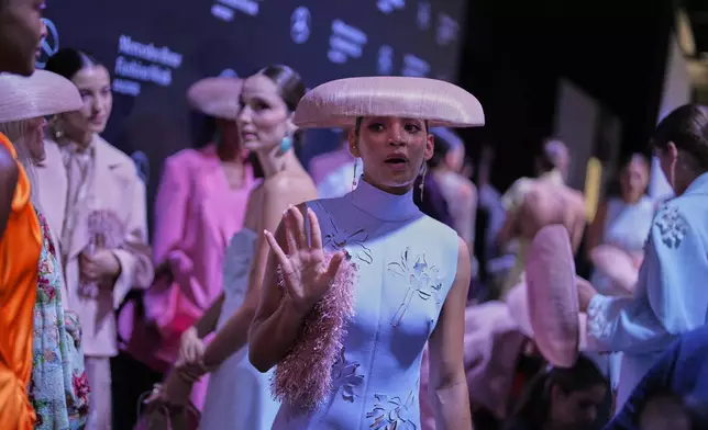 Models wear designs by Isabel Sanchis backstage during the brand's show at Fashion Week in Madrid, Spain, Friday, Sept. 19, 2025. (AP Photo/Manu Fernandez)