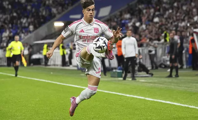 Lyon's Afonso Moreira controls the ball in the air during the French League One soccer match between Olympique Lyon and Angers at Groupama stadium in Decines, outside Lyon, France, Friday, Sept. 19, 2025. (AP Photo/Laurent Cipriani)