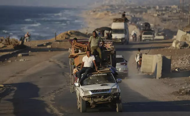 Displaced Palestinians fleeing from northern Gaza Strip move with their belongings along the Sea Road, in central Gaza, Thursday, Sept. 4, 2025. (AP Photo/Jehad Alshrafi)
