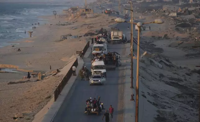 Displaced Palestinians fleeing from northern Gaza Strip move with their belongings along the Sea Road, in central Gaza, Thursday, Sept. 4, 2025. (AP Photo/Jehad Alshrafi)