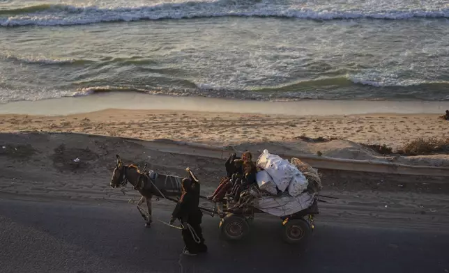 Displaced Palestinians fleeing from northern Gaza Strip move with their belongings along the Sea Road, in central Gaza, Thursday, Sept. 4, 2025. (AP Photo/Jehad Alshrafi)