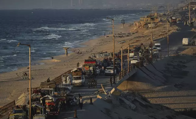 Displaced Palestinians fleeing from northern Gaza Strip move with their belongings along the Sea Road, in central Gaza, Thursday, Sept. 4, 2025. (AP Photo/Jehad Alshrafi)