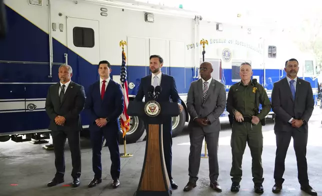 Vice President JD Vance, center, speaks next to officials including, from left to right, HUD Regional Administrator William Spencer, United States Attorney for the Central District of California Bill Essayli, FBI Los Angeles Assistant Director Akil Davis, US Border Patrol Sector Chief Gregory Bovino and ICE Field Office Director Ernie Santacruz at the Wilshire Federal Building Friday, June 20, 2025, in Los Angeles. (AP Photo/Jae C. Hong, File)