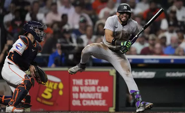 New York Yankees' Jose Caballero, right, reacts after a pitch from Houston Astros starting pitcher Framber Valdez during the fourth inning of a baseball game in Houston, Tuesday, Sept. 2, 2025. (AP Photo/Ashley Landis)