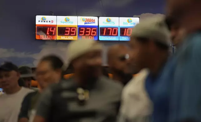 People wait in line to buy lottery tickets at the Lotto Store just inside the California border Wednesday, Sept. 3, 2025, near Primm, Nev. (AP Photo/John Locher)