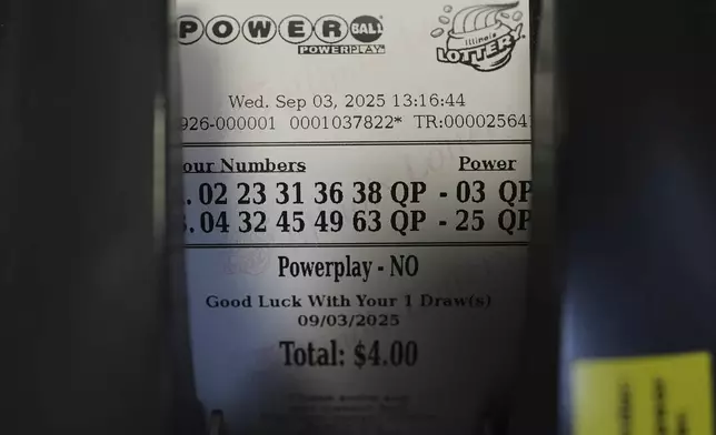 A Powerball lottery ticket is printed out of a lottery machine at a convenience store in Northbrook, Ill., Wednesday, Sept. 3, 2025. (AP Photo/Nam Y. Huh)