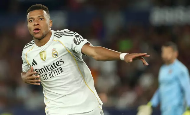 Real Madrid's Kylian Mbappe, celebrates after scoring his side's fourth goal with a penalty kick during the Spanish La Liga soccer match between Levante and Real Madrid at the Ciutat de Valencia stadium in Valencia, Spain, Tuesday, Sept. 23, 2025. (AP Photo/Alberto Saiz)