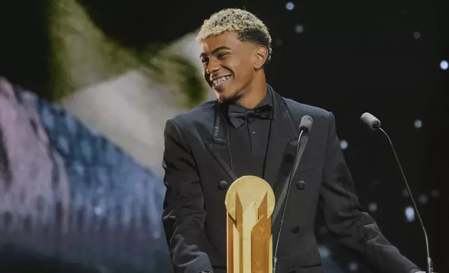 Barcelona's Spanish player Lamine Yamal receives the Kopa Trophy during the 69th Ballon d'Or (Golden Ball) award ceremony at Theatre du Chatelet in Paris, Monday, Sept. 22, 2025. (AP Photo/Thibault Camus)