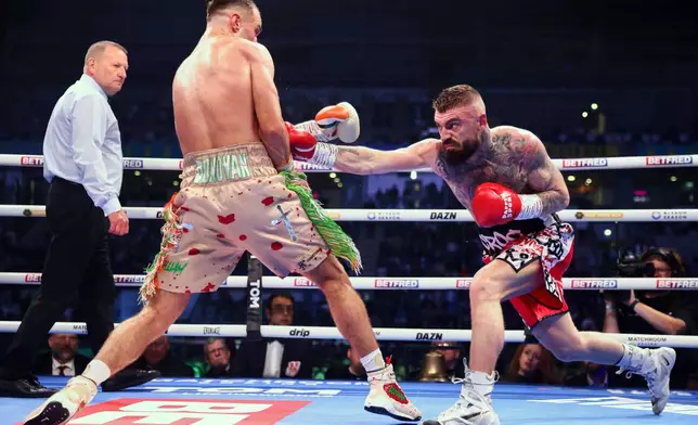 Paddy Donovan, left, takes on Lewis Crocker, right, during an IBF world welterweight bout at the SSE Arena, Saturday, Sept. 13, 2025, in Belfast, Northern Ireland. (Peter Morrison/PA via AP)