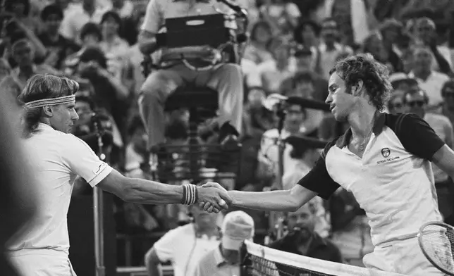 John McEnroe, right, shakes hands after defeating Björn Borg, left, in the final at the National Tennis Center in New York, Sept. 13, 1981. (AP Photo/Ron Frehm, File)