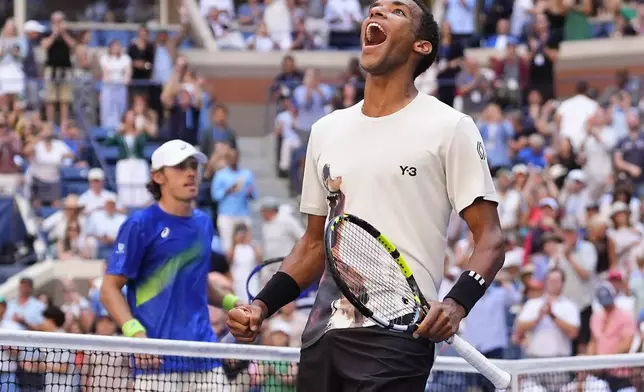 Felix Auger-Aliassime, of Canada, reacts after defeating Alex de Minaur, of Australia, during the quarterfinal round of the U.S. Open tennis championships, Wednesday, Sept. 3, 2025, in New York. (AP Photo/Yuki Iwamura)