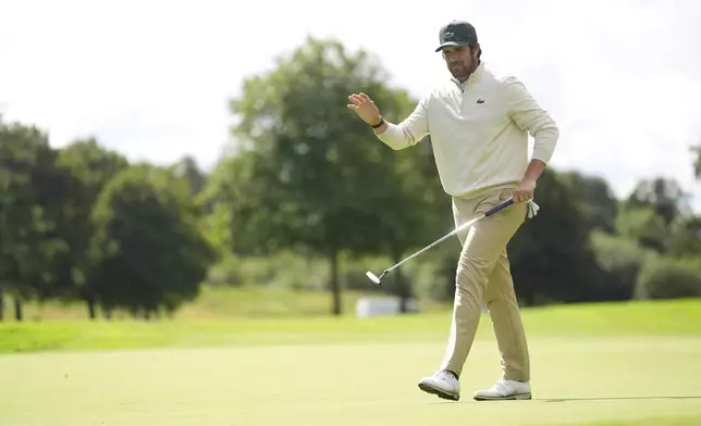 Nacho Elvira, of Spain, waves after a putt during the Irish Open golf tournament, Thursday, Sept. 4, 2025, at The K Club in Staffan, Ireland. (Brian Lawless/PA via AP)