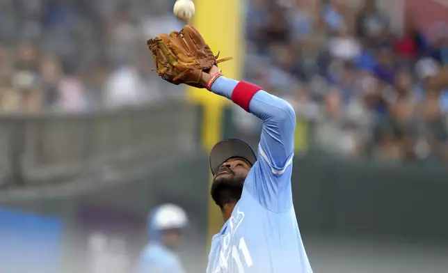 Kansas City Royals third baseman Maikel Garcia catches a foul ball hit by Toronto Blue Jays' Davis Schneider during the third inning of a baseball game Saturday Sept. 20, 2025, in Kansas City, Mo. (AP Photo/Ed Zurga)